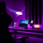 woman in black dress standing near black laptop computer on brown wooden desk